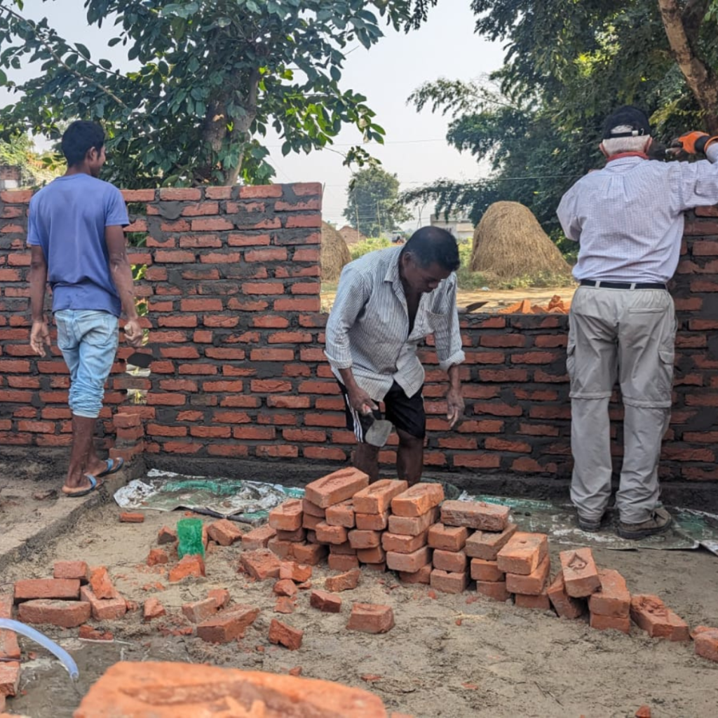 locla tradespeople and volunteers laying brick Nepal