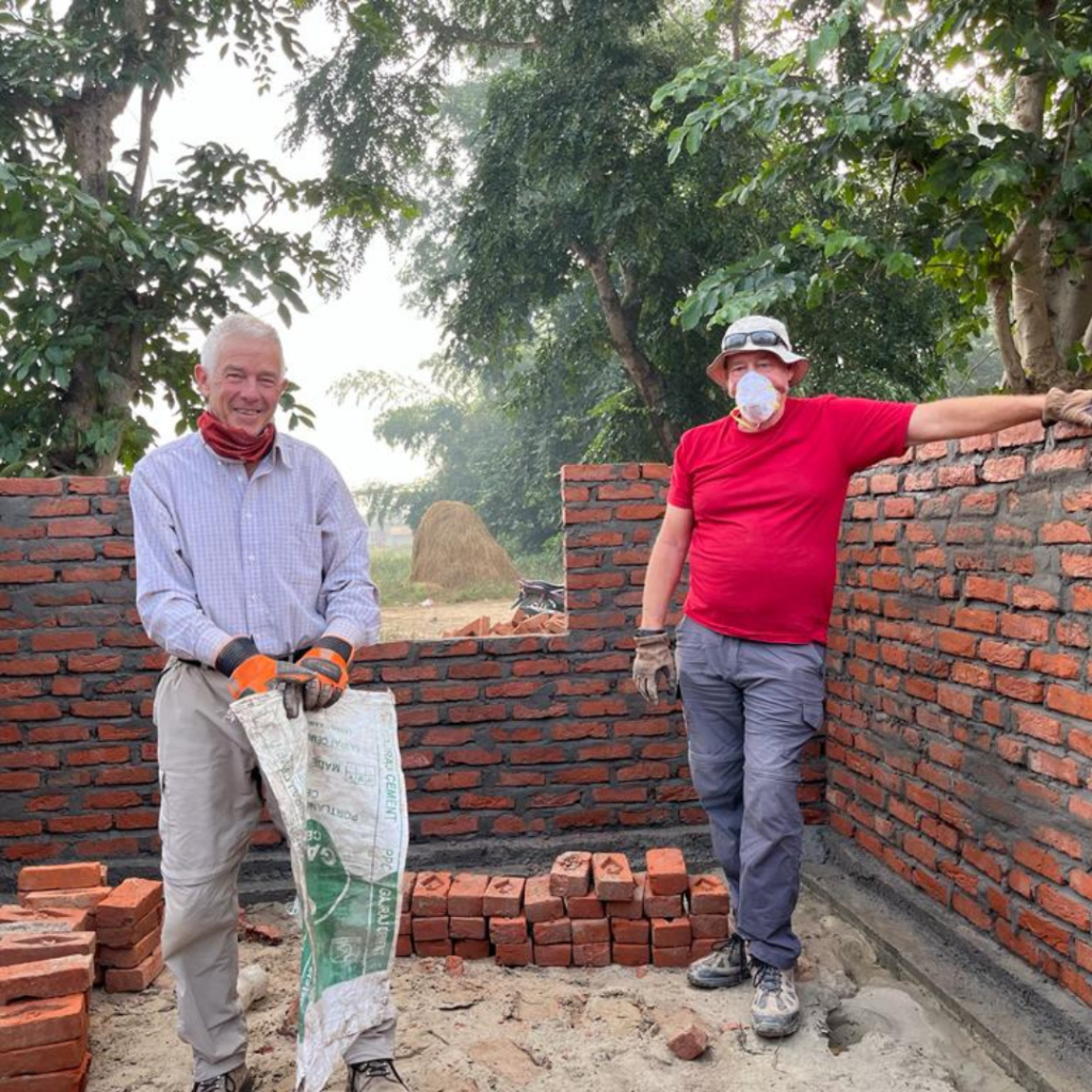 volunteers mixing cement Nepal