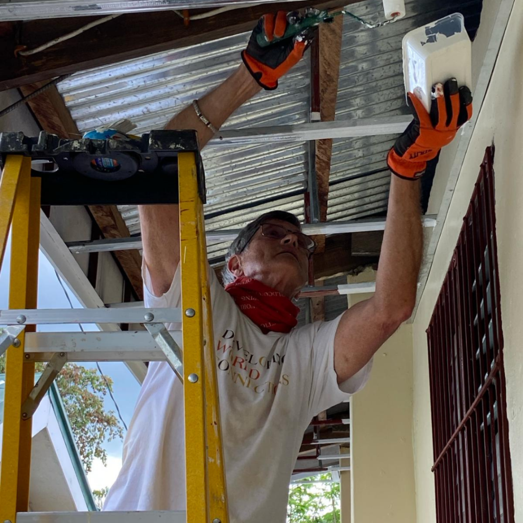 DWC volunteer painting soffit Philippines
