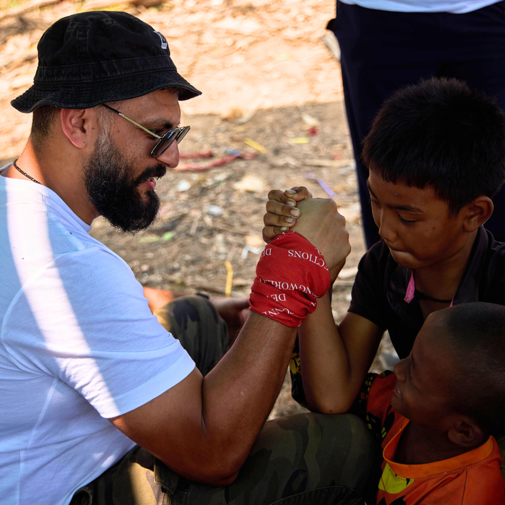 Salesforce volunteer arm wrestling with local child