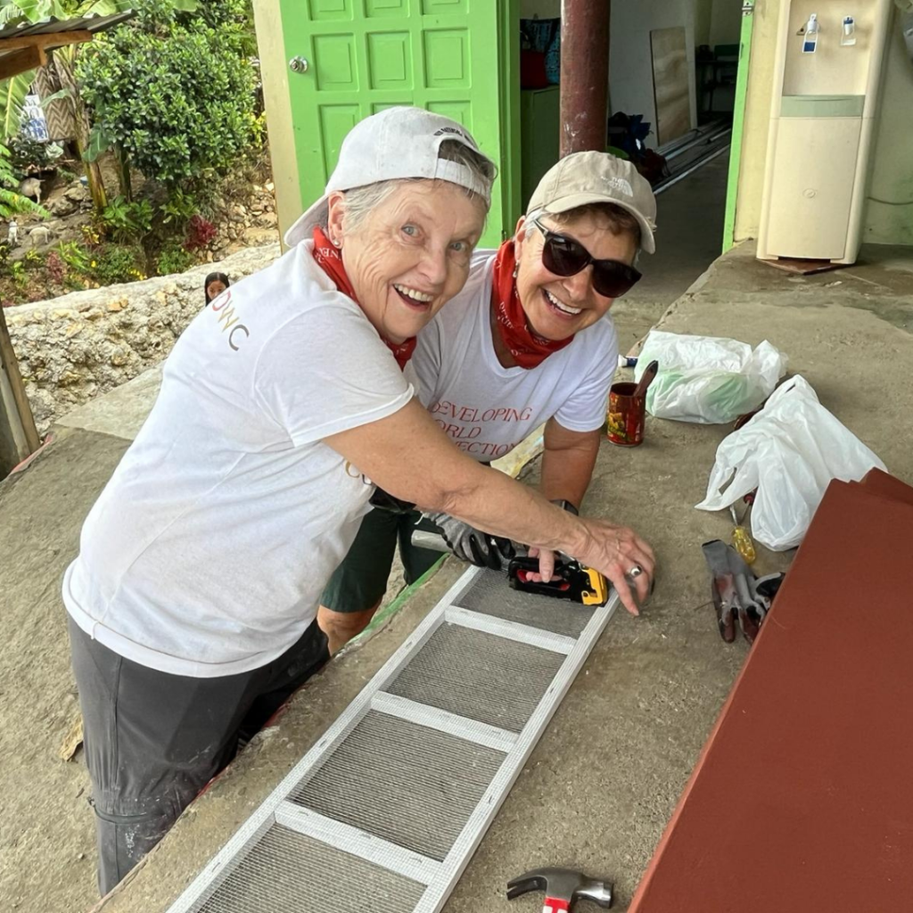 Volunteers Cutting screens for soffits Philippines
