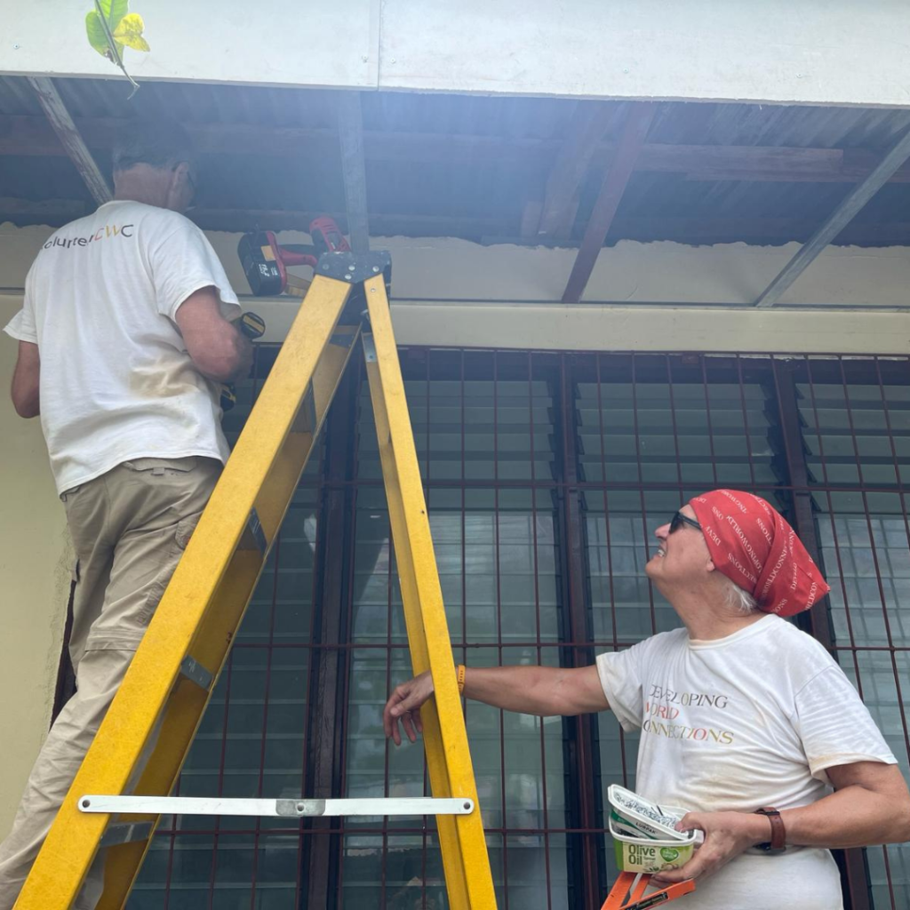 DWC volunteer working on soffit with handdrill Philippines