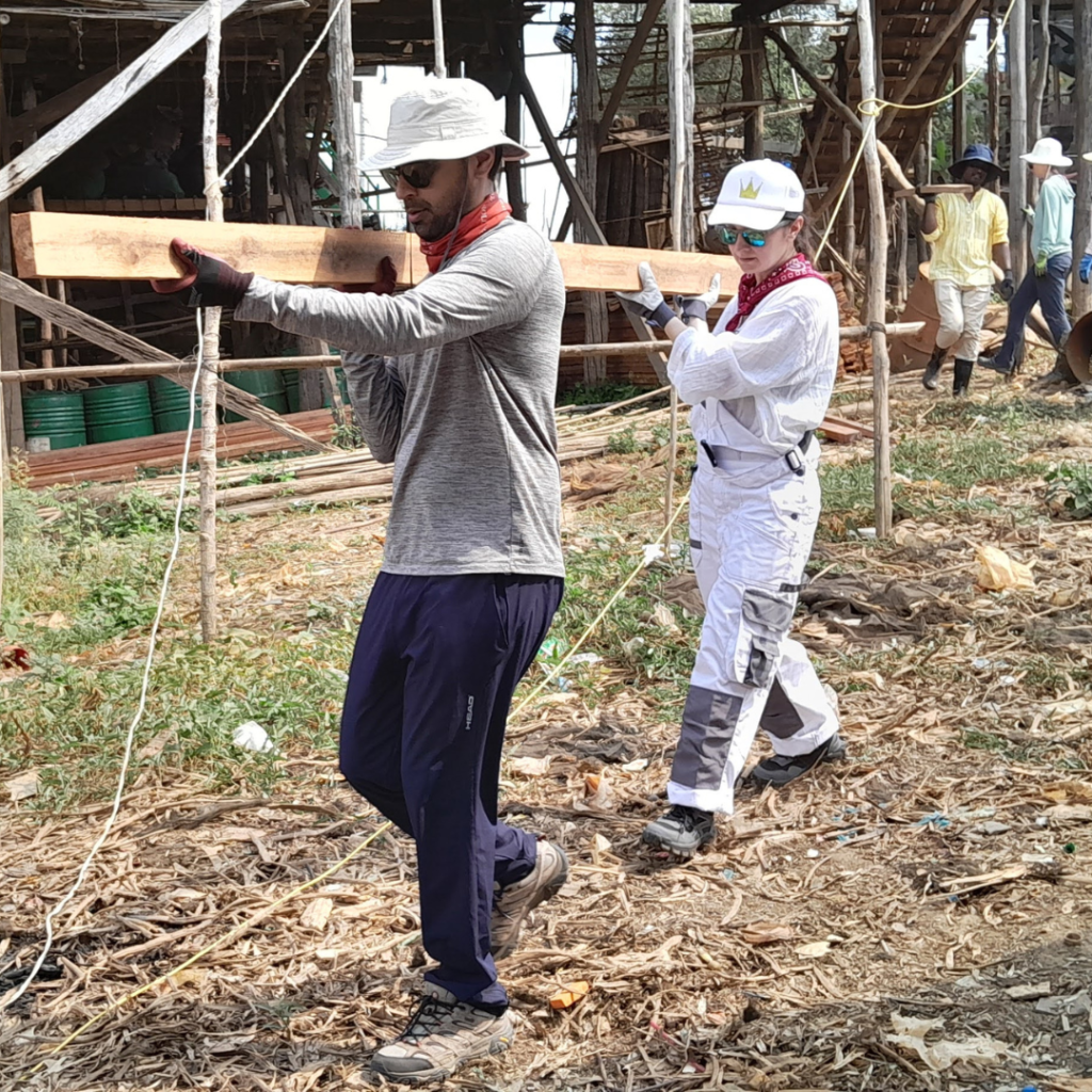 Salesforce team carrying beams Cambodia