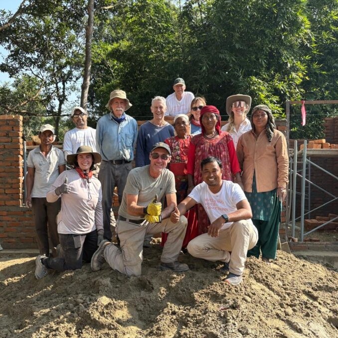 Nepal volunteers posing on sand pile