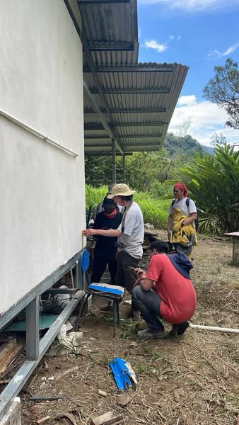 Volunteers working on outside wll of building Costa Rica