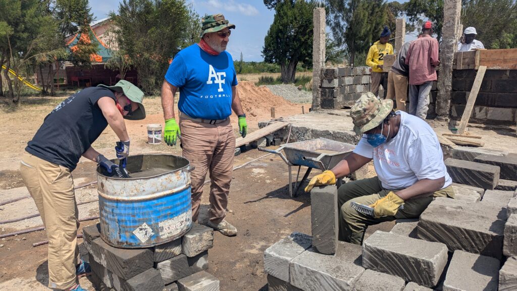 Volunteers working with bricks Kenya