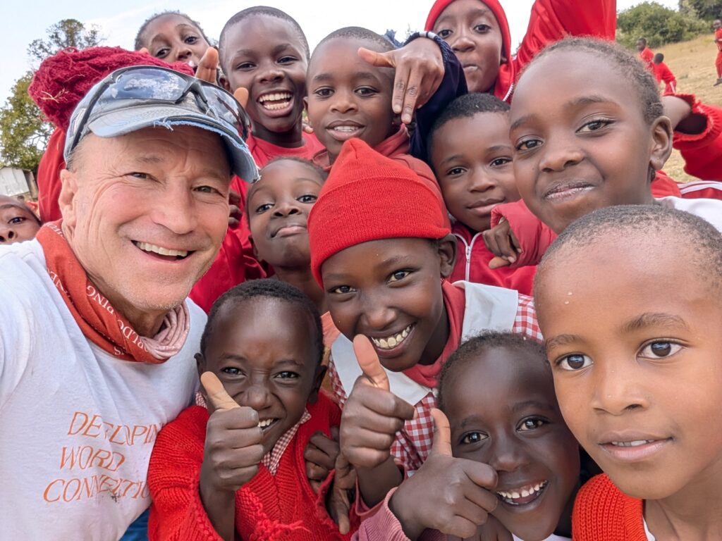Team Leader posing with local children Kenya