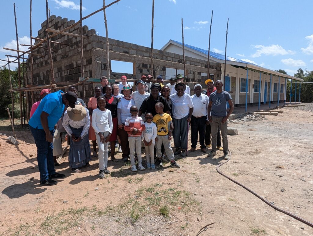Volunteers and locals posing in front of project Kenya