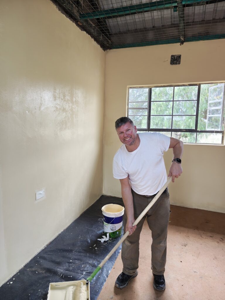Painting walls at project site in Kenya