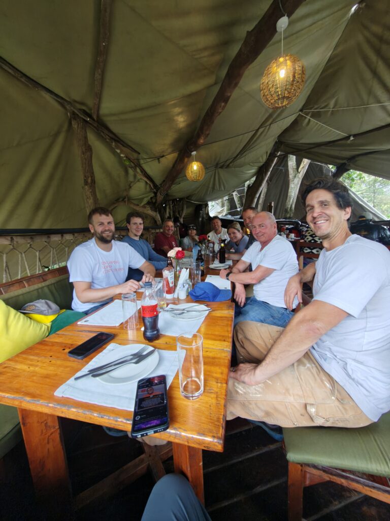 Volunteers posing at lunch table Kenya