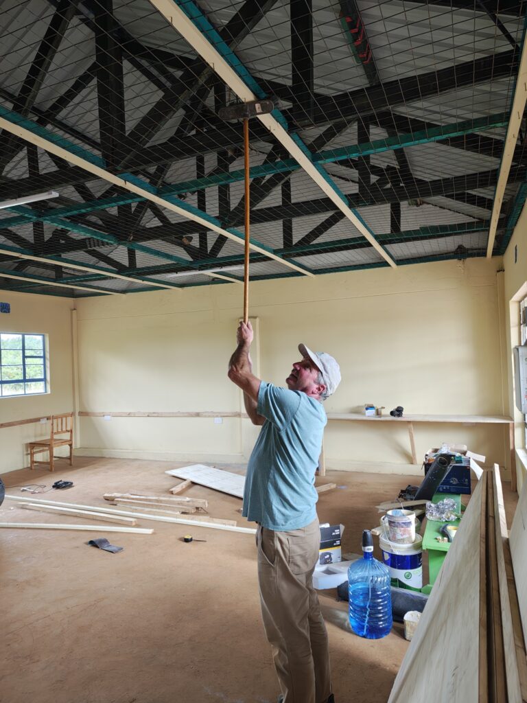Painting ceiling at project site Kenya