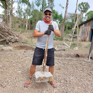 Volunteer with hand impact tool. Kenya