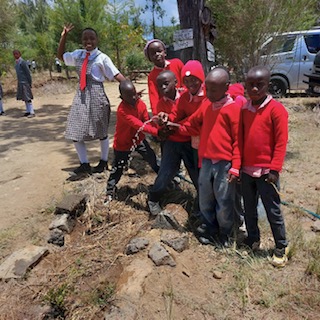 Local school children watering plants Kenya
