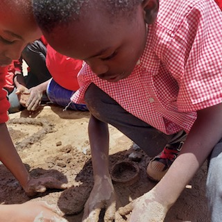 School kids playing in mud Kenya