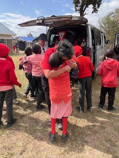 Child getting a hug in Kenya