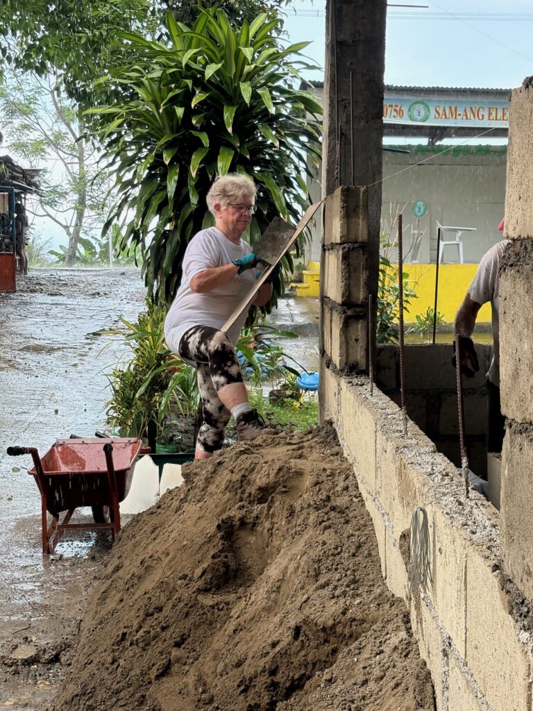 Volunteers in Philippines building cinder block wall