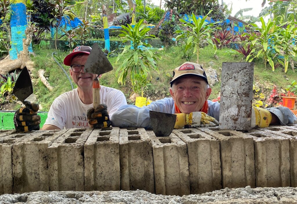 Volunteers in Philippines with mortar and spatulas