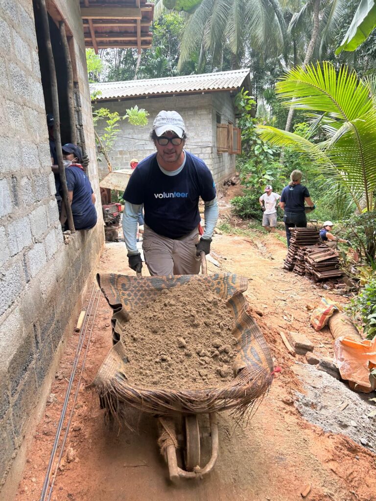 Volunteer with wheelbarrow Sri Lanka