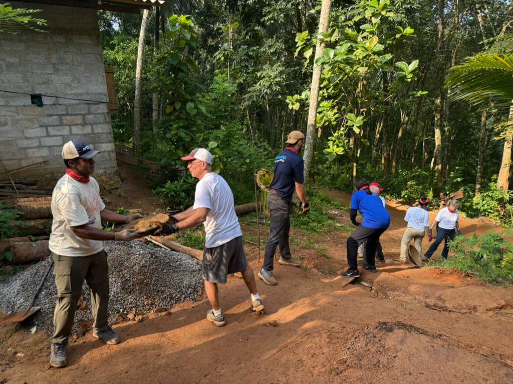 Volunteers passing sand in bowls Sri Lanka
