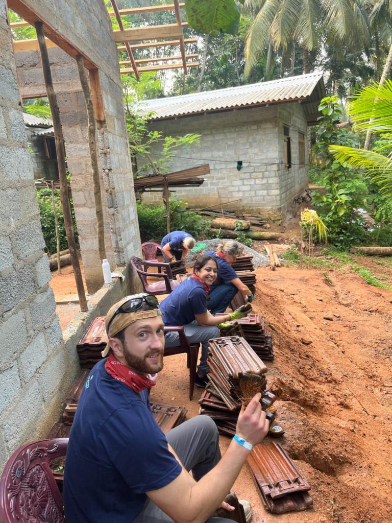 Volunteers cleaning roof tiles Sri Lanka