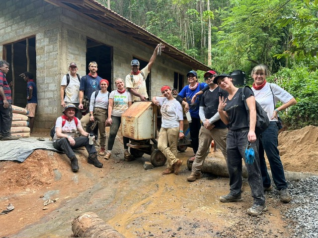 Volunteers using cement mixer Sri Lanka
