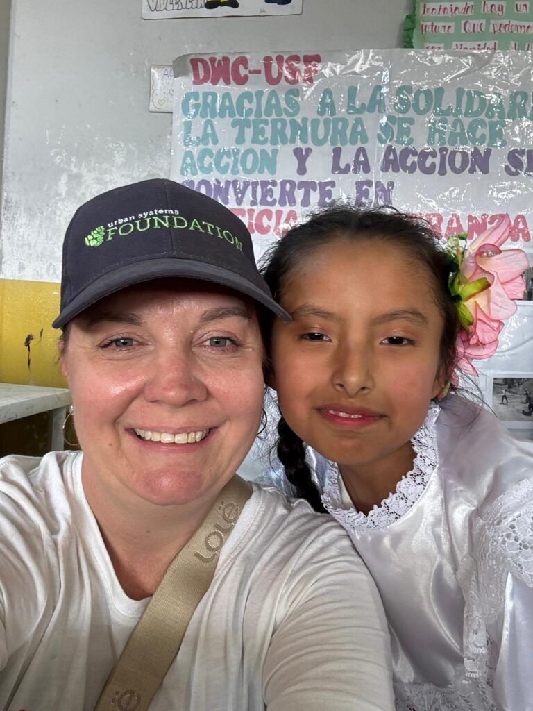 Volunteer posing with school girl Peru