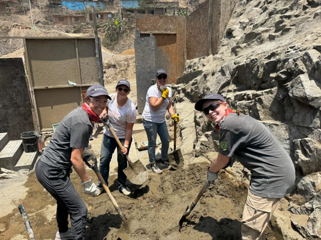 Volunteers shoveling at project site Peru